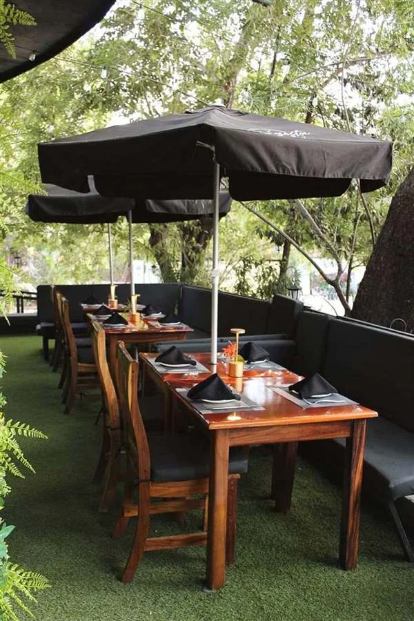 Tables under umbrellas in the Lantern Garden