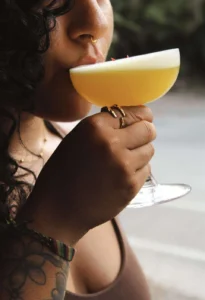 Guest holding a classic sour cocktail