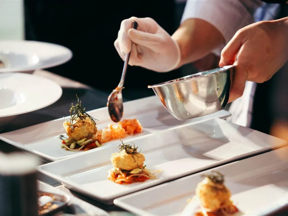 Chefs plating a tasting course