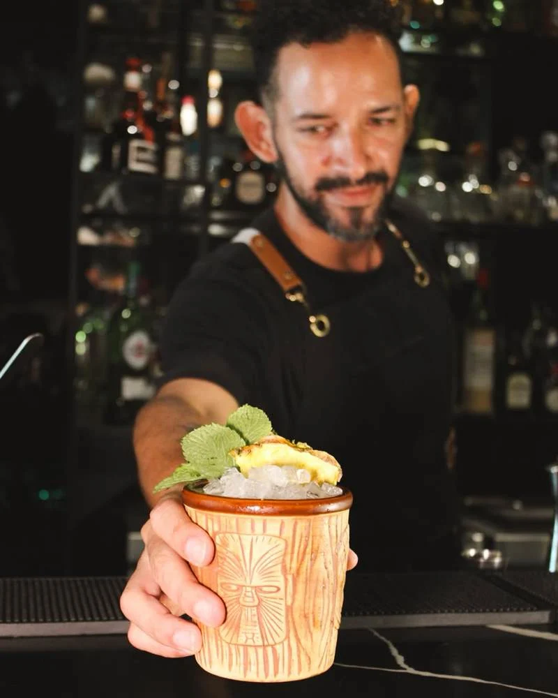 Our bartender serving a tiki cocktail