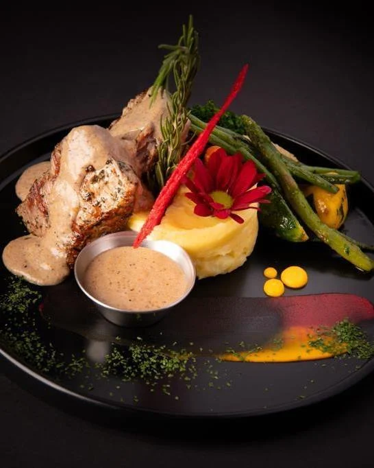 Plated filet mignon with vegetables and sauce
