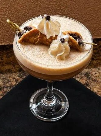 Espresso martini topped with a cannoli