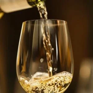 White wine being poured into a glass