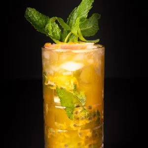 Tall cocktail garnished with fresh mint